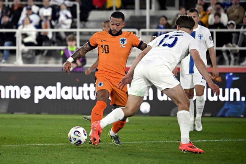 Netherlands' forward #10 Memphis Depay (L) attempts to get past Finland's defender #15 Miro Tenho during the 2026 FIFA World Cup Qualifying Group G football match between Finland and the Netherlands in Helsinki on June 7, 2025.  Markku Ulander / LEHTIKUVA / AFP