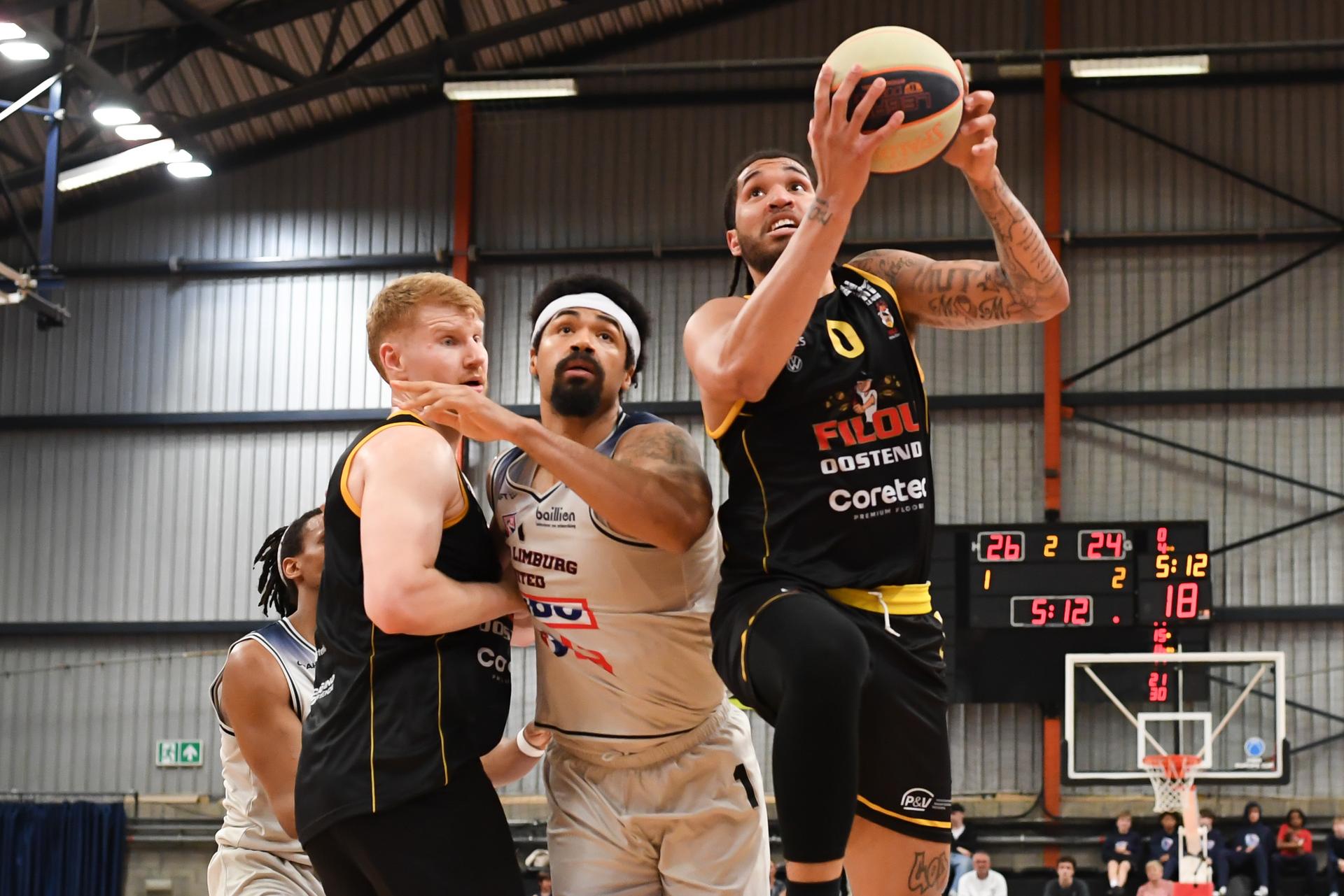 Oostende's Matthias Tass, Limburg's Javion Ogunyemi and Oostende's Timmy Allen pictured in action during a basketball match between Limburg United and BC Oostende, Friday 11 April 2025 in Hasselt, on day 32 of the 'BNXT League' first division basket championship. BELGA PHOTO JILL DELSAUX