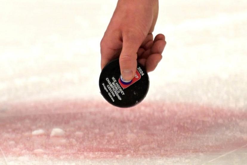 A referee lifts the puck during the IIHF Ice Hockey Men's World Championships match between USA and Germany in Ostrava, Czech Republic on May 11, 2024.  Joe Klamar / AFP