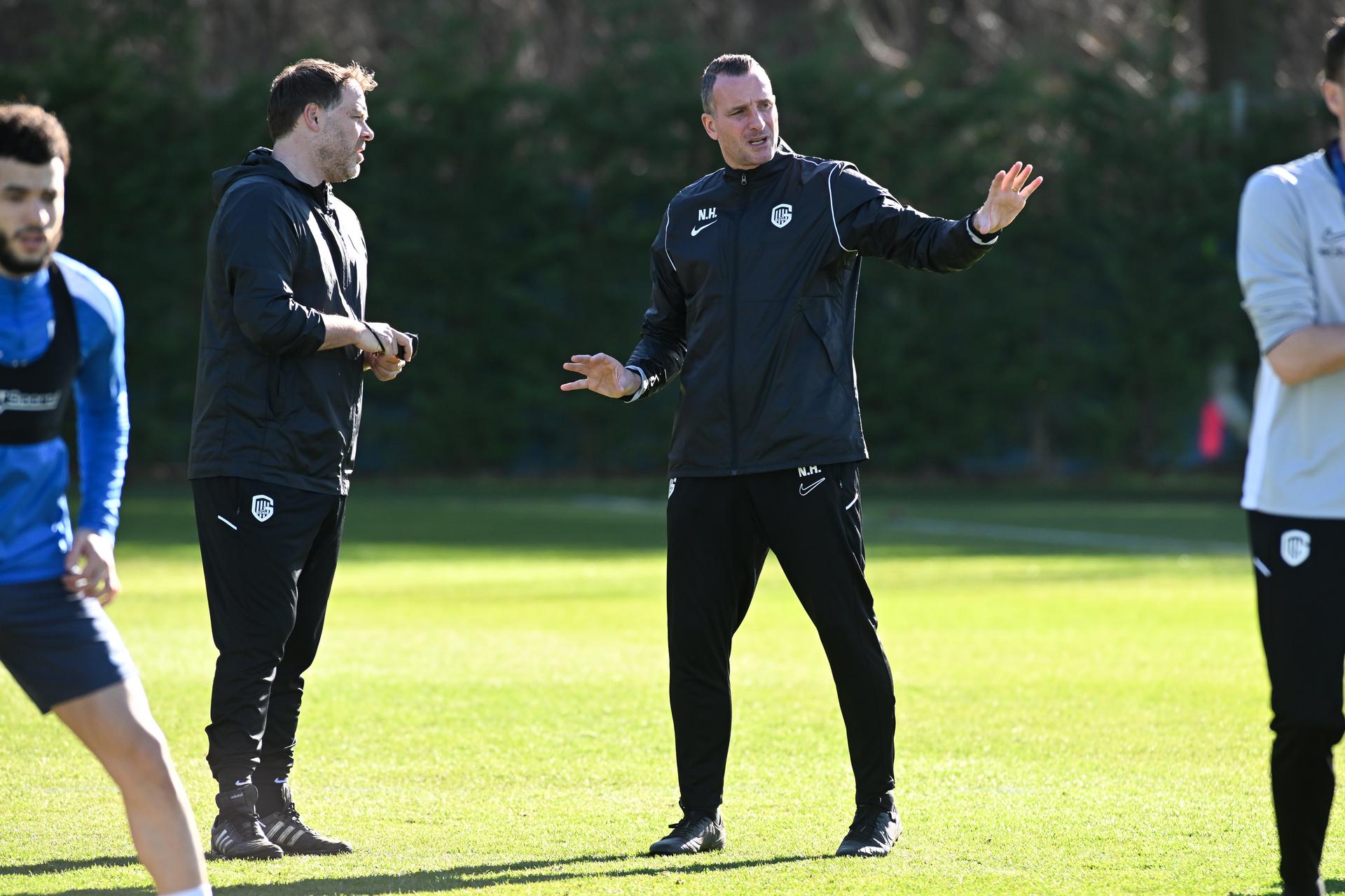 Genk's assistant coach Johan Van Rumst and Genk's head coach Nicky Hayen pictured during a training session of Belgian soccer team KRC Genk, Wednesday 25 February 2026 in Genk. The team is preparing for tomorrow's match against Croatian GNK Dinamo Zagreb, in the play-off for the knockout phase of the UEFA Europa League tournament. Genk won the first leg 1-3. BELGA PHOTO JILL DELSAUX