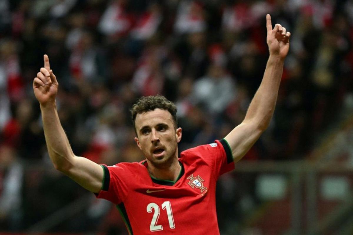 Portugal's forward #21 Diogo Jota reacts after Poland's defender #05 Jan Bednarek scored an own goal during the UEFA Nations League, League A Group A1 football match Poland vs Portugal at the National Stadium in Warsaw, Poland on October 12, 2024.  Sergei GAPON / AFP