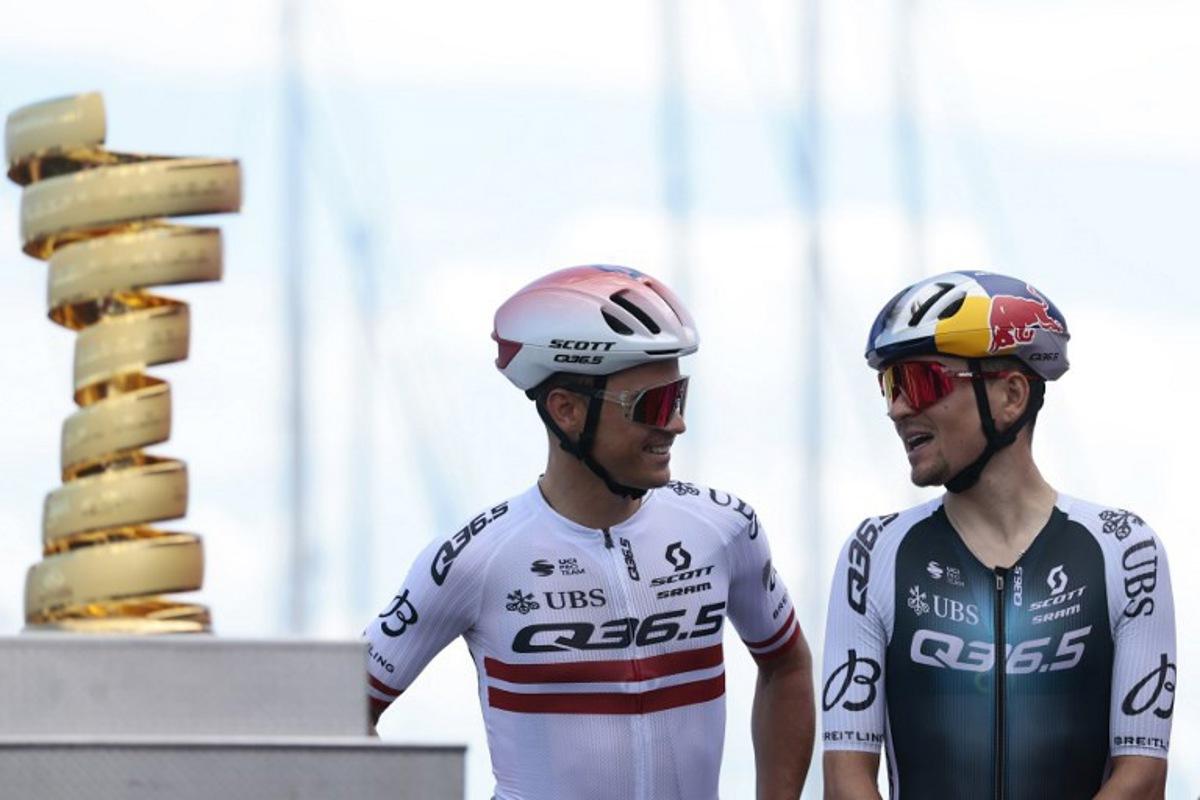 Q36.5 Pro Cycling team's British rider Thomas Pidcock and Q36.5 Pro Cycling team's Latvian rider Emils Liepins are pictured on stage before the 8th stage of the 108th Giro d'Italia cycling race of 197kms from Giulianova to Castelraimondo on May 17, 2025.  Luca Bettini / AFP
