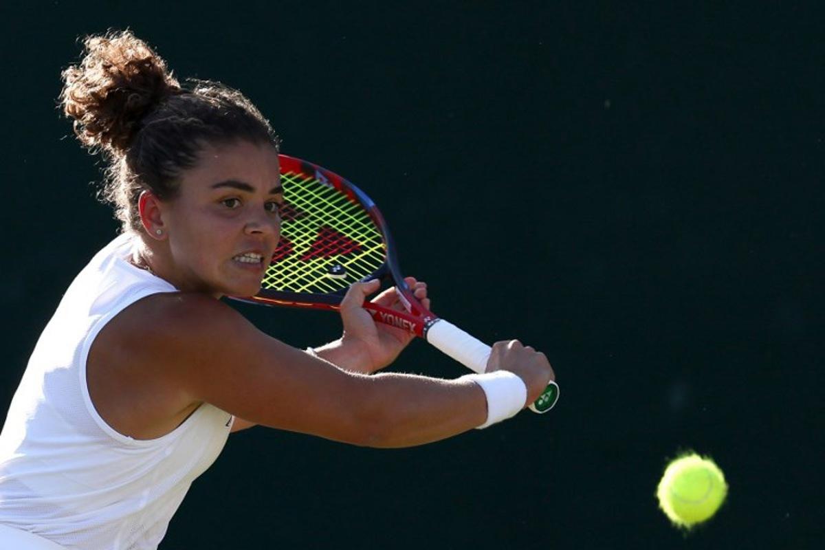 Italy's Jasmine Paolini plays a backhand return to Russia's Kamilla Rakhimova during their women's singles second round tennis match on the third day of the 2025 Wimbledon Championships at The All England Lawn Tennis and Croquet Club in Wimbledon, southwest London, on July 2, 2025.  Adrian Dennis / AFP