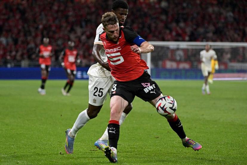 Rennes' French defender #03 Adrien Truffert (R) fights for the ball with Nice's French forward #25 Mohamed-Ali Cho during the French L1 football match between Stade Rennais FC and OGC Nice at Roazhon Park stadium in Rennes, western France on May 10, 2025.  DAMIEN MEYER / AFP