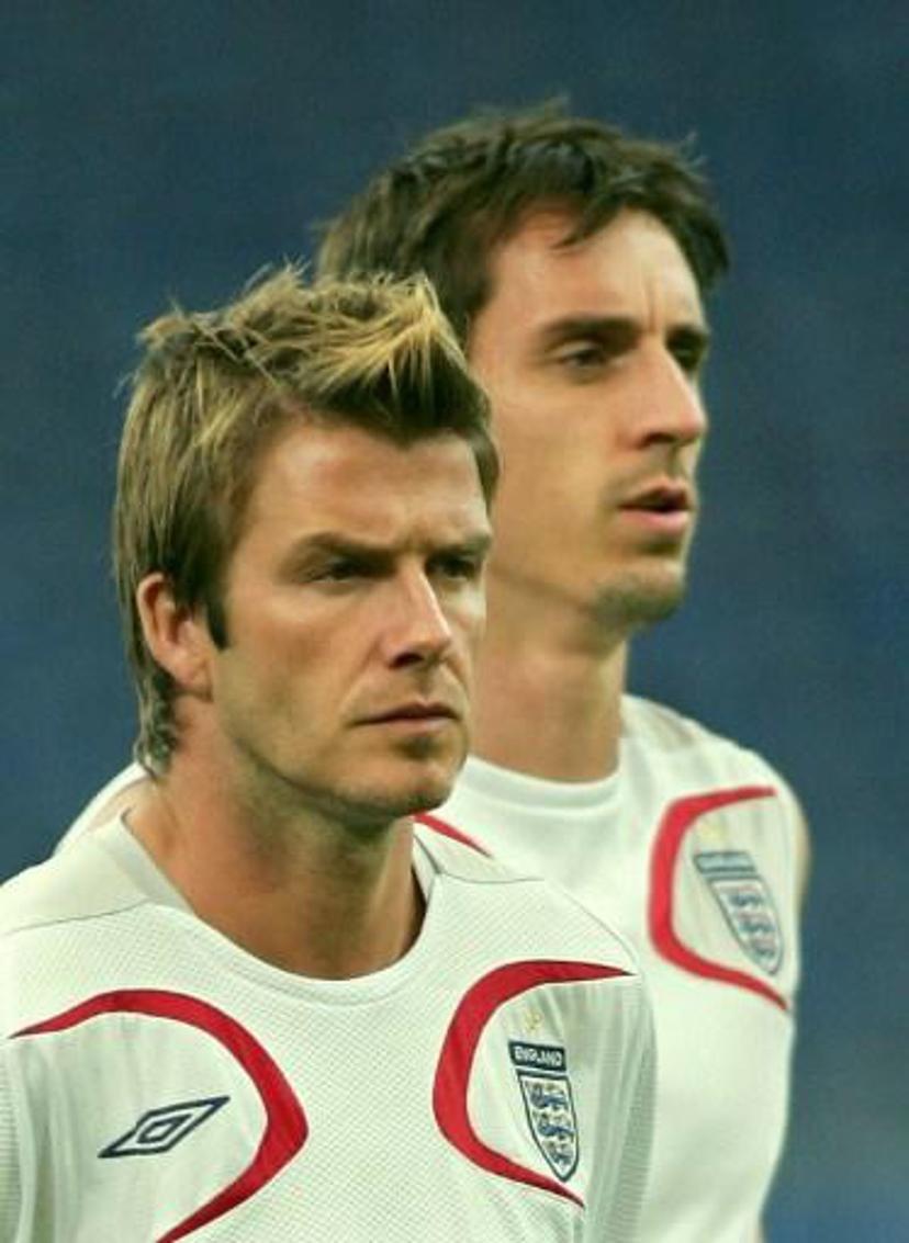English midfielder David Beckham (L) and defender Gary Neville (R) warm up during a session at the Arena in Gelsenkirchen, 30 June 2006. England plays Portugal in their quarter-final match tomorrow for the World Cup 2006. AFP PHOTO/ADRIAN DENNIS