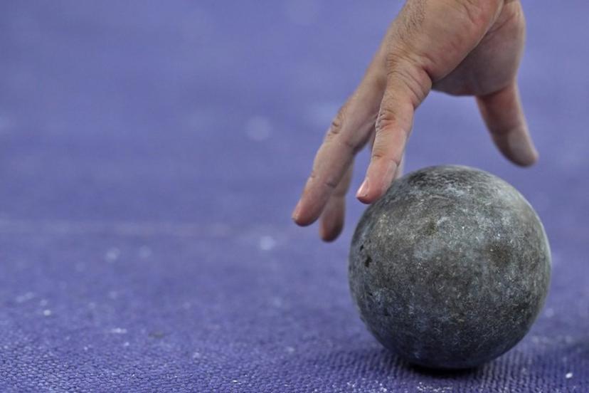 Romania's Andrei Rares Toader picks up his shot put to compete in the men's shot put qualification of the athletics event at the Paris 2024 Olympic Games at Stade de France in Saint-Denis, north of Paris, on August 2, 2024.  Ben STANSALL / AFP
