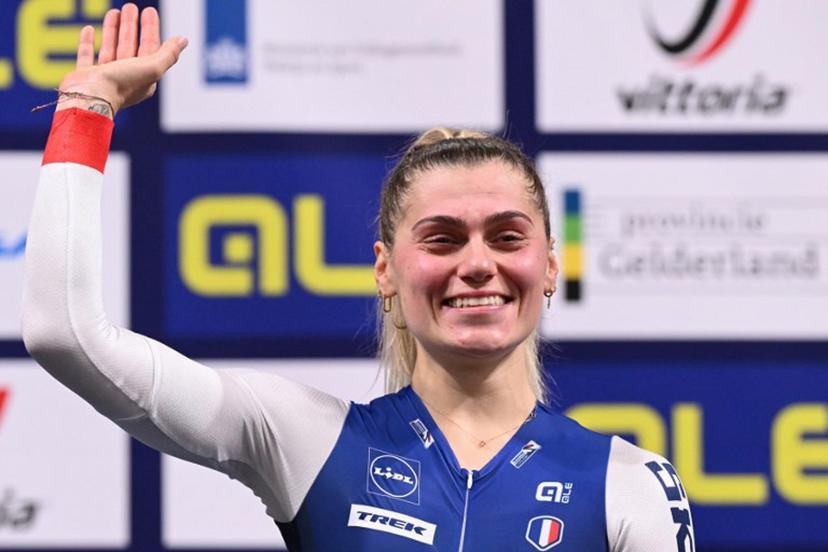 First placed France's Clara Copponi reacts as she celebrates on the podium for the Women's Scratch race during the second day of the UEC European Track Cycling Championships at the Omnisport indoor arena in Apeldoorn, on January 11, 2024.  JOHN THYS / AFP