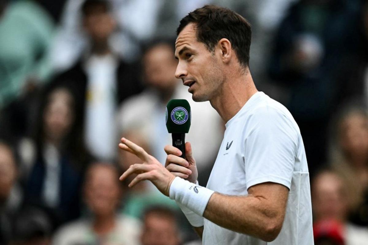 Britain's Andy Murray delivers a speech at the end of his men's doubles tennis match with his brother Britain's Jamie Murray, during a farewell ceremony to celebrate his last Wimbledon, on the fourth day of the 2024 Wimbledon Championships at The All England Lawn Tennis and Croquet Club in Wimbledon, southwest London, on July 4, 2024.  Ben Stansall / AFP