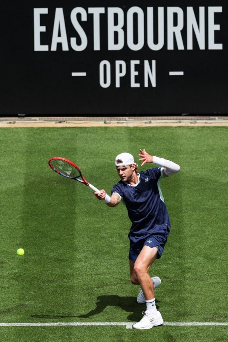 Belgium's Zizou Bergs plays a forehand return to Brazil's Joao Fonseca during their men's singles tennis match on day one at the Rothesay Eastbourne International tennis tournament in Eastbourne, southern England, on June 23, 2025.  Adrian Dennis / AFP