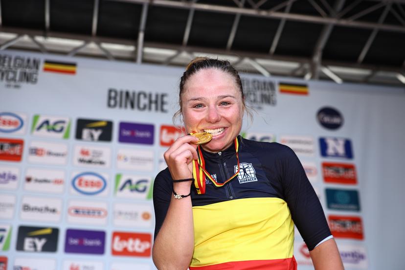 Belgian Justine Ghekiere celebrates on the podium in the national jersey after winning the women's elite road race of the Belgian Cycling Championships, 132,8 km from and to the Grand Place square in Binche on Sunday 29 June 2025. BELGA PHOTO DAVID PINTENS
