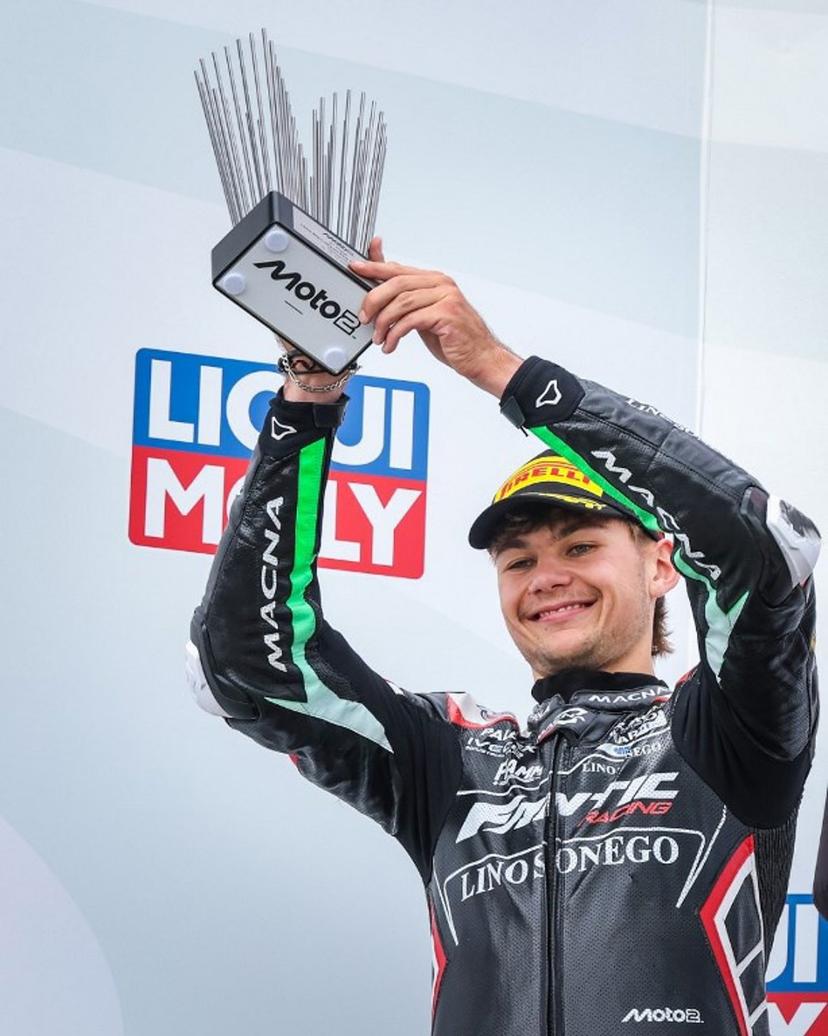 Second-placed Fantic Racing Team's Belgiums Moto2 rider Barry Baltus celebrates on the podium with his trophy after the German Moto2 Grand Prix at the Sachsenring racing circuit, in Hohenstein-Ernstthal near Chemnitz, eastern Germany on July 13, 2025.  Ronny Hartmann / AFP