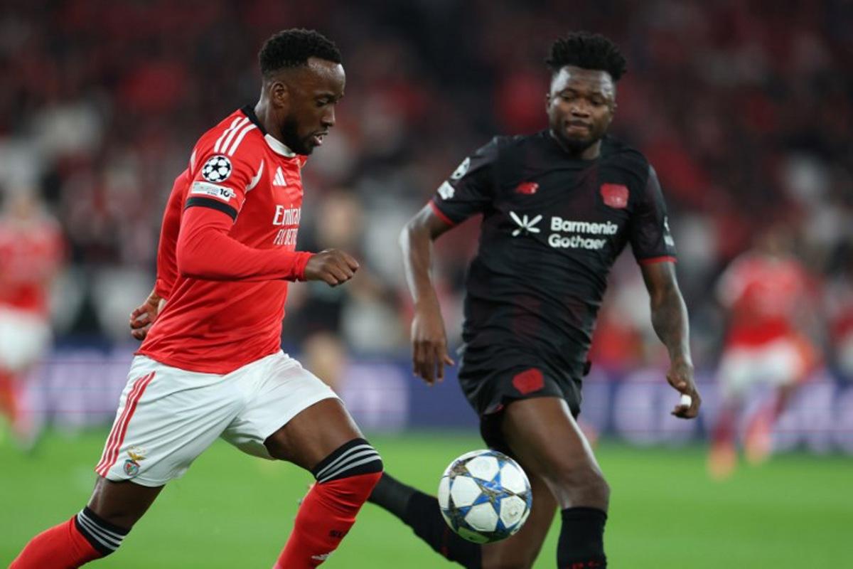 SL Benfica's Belgian forward #11 Dodi Lukebakio (L) and Bayer Leverkusen's Burkinabe defender #12 Edmond Tapsoba vie for the ball during the UEFA Champions League league phase day 4 football match between SL Benfica and Bayer Leverkusen at Estadio da Luz in Lisbon on November 5, 2025.  PATRICIA DE MELO MOREIRA / AFP