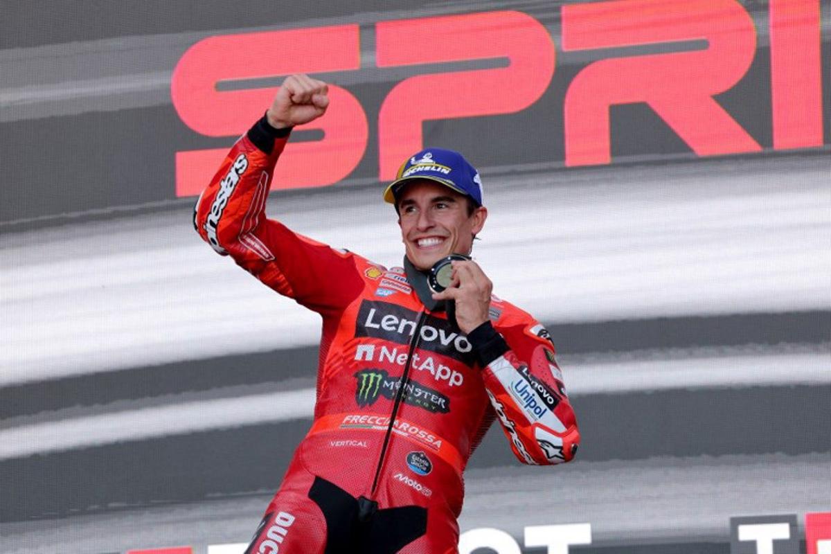 Team Ducati Lenovo Team's Marc Marquez celebrates on the podium winning the sprint race of the MotoGP Aragon Grand Prix at the Motorland circuit in Alcaniz, northeastern Spain, on June 7, 2025.   LLUIS GENE / AFP