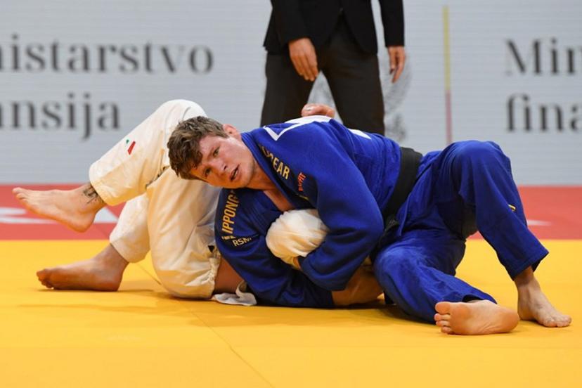 Belgium's Matthias Casse (blue) and Italy's Antonio Esposito (white) compete in the men's -81kg category during the European Championships judo in Podgorica, Montenegro, on April 25, 2025. The tournament is taking place from April 23 to 27, 2025.   SAVO PRELEVIC / AFP