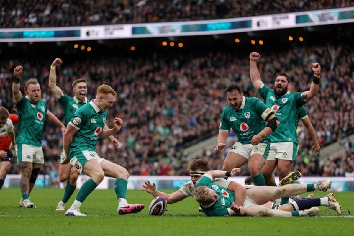 Ireland's full-back Jamie Osborne (C-on ground) goes over to score a try during the Six Nations international rugby union match between England and Ireland at Allianz Stadium, Twickenham, in south-west London, on February 21, 2026.  Adrian Dennis / AFP