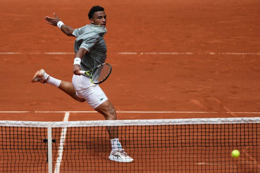 France's Arthur Fils plays a backhand return to Spain's Jaume Munar during their men's singles match on day 5 of the French Open tennis tournament on Court Suzanne-Lenglen at the Roland-Garros Complex in Paris on May 29, 2025.  Dimitar DILKOFF / AFP