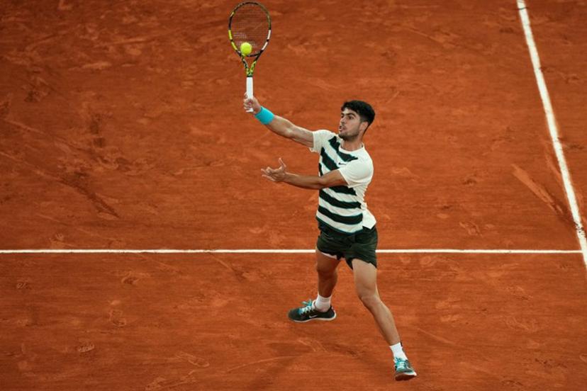 Spain's Carlos Alcaraz plays a forehand return to Italy's Lorenzo Musetti during their men's singles semi-final match on day 13 of the French Open tennis tournament on Court Philippe-Chatrier at the Roland-Garros Complex in Paris on June 6, 2025.  Dimitar DILKOFF / AFP