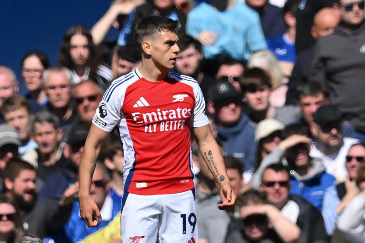 Arsenal's Belgian midfielder #19 Leandro Trossard reacts after scoring the opening goal of the English Premier League football match between Everton and Arsenal at Goodison Park in Liverpool, north west England on April 5, 2025. ANDY BUCHANAN / AFP