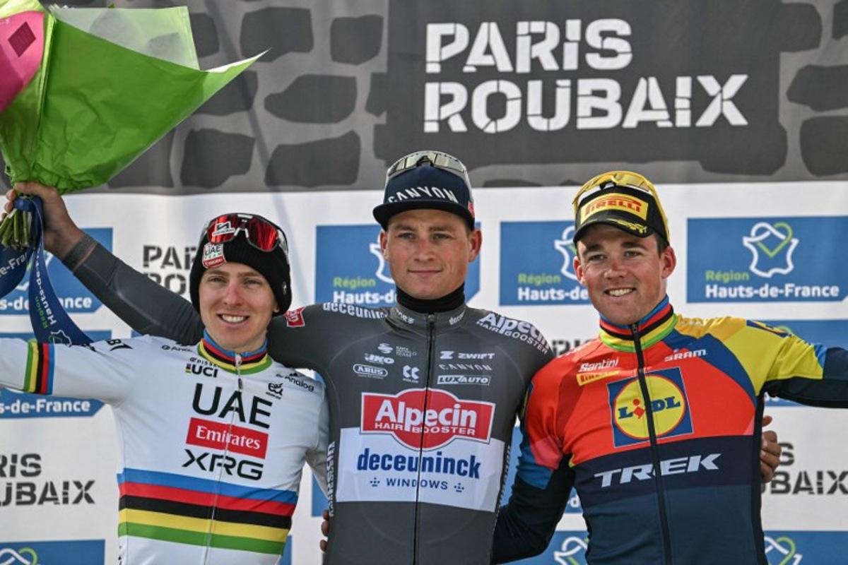 Second placed UAE Team Emirate's Slovenian rider Tadej Pogacar (L), First placed Alpecin-Deceuninck's Dutch rider Mathieu van der Poel and Third placed Lidl-Trek's Danish rider Mads Pedersen celebrate on the podium of the 122nd edition of the Paris-Roubaix one-day classic cycling race, 259,2 km between Compiegne and Roubaix, northern France on April 13, 2025. Jeff PACHOUD / AFP