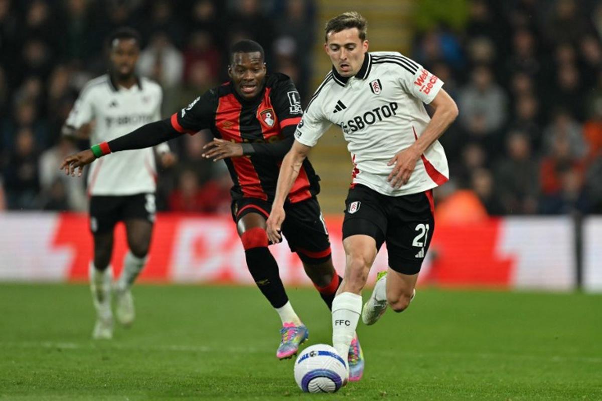 Fulham's Belgian defender #21 Timothy Castagne (R) runs away from Bournemouth's Burkinabe striker #11 Dango Ouattara (L) during the English Premier League football match between Bournemouth and Fulham at the Vitality Stadium in Bournemouth, southern England on April 14, 2025. Glyn KIRK / AFP