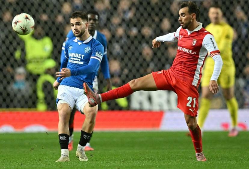 Sporting Braga's Portuguese midfielder #21 Ricardo Horta (R) vies with Rangers' Belgian midfielder #43 Nicolas Raskin during the UEFA Europa League league-stage football match between Rangers and CS Braga at the Ibrox Stadium in Glasgow on November 27, 2025. ANDY BUCHANAN / AFP