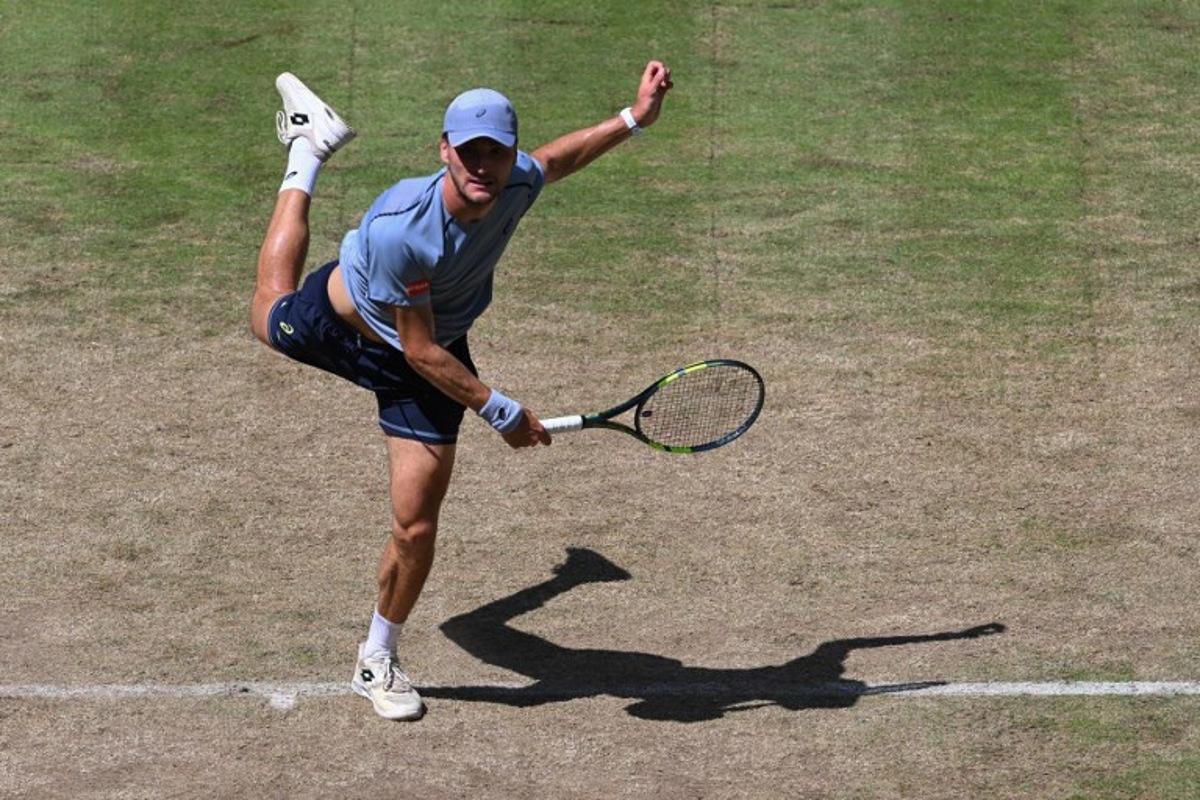 Belgium's Raphael Collignon returns the ball to Germany's Alexander Zverev during their men's singles quarter-final match of the Halle Open ATP tennis tournament in Halle, western Germany, on June 19, 2026. CARMEN JASPERSEN / AFP