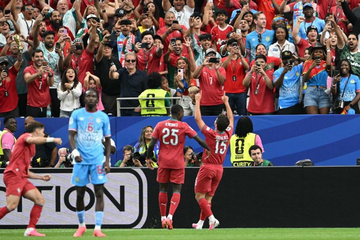Portugal's midfielder #15 Joao Neves (R) celebrates after scoring the opening goal during the 2026 World Cup Group K football match between Portugal and the Democratic Republic of Congo at the Houston Stadium in Houston on June 17, 2026. RONALDO SCHEMIDT / AFP