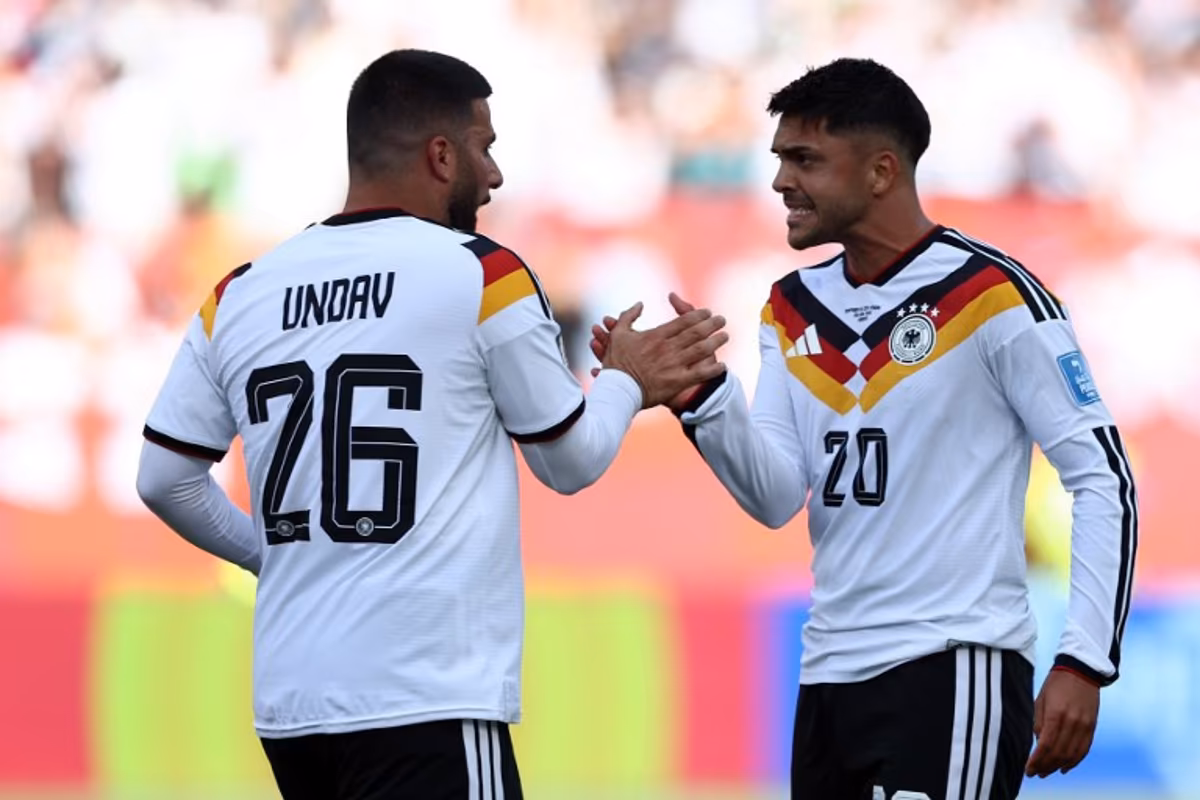 Germany's forward #26 Deniz Undav (L) is congratulated by Germany's midfielder #20 Nadiem Amiri after scoring his team's first goal during the 2026 World Cup Group E football match between Germany and Ivory Coast at the Toronto Stadium in Toronto on June 20, 2026. Cole Burston / AFP