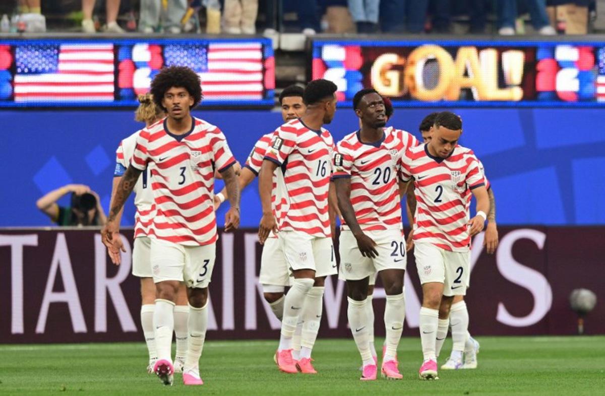 US defender #16 Alex Freeman, forward #20 Folarin Balogun and defender #02 Sergino Dest celebrate their team's first goal scored own goal by Paraguay's midfielder #16 Damian Bobadilla during the 2026 World Cup Group D football match between USA and Paraguay at the Los Angeles Stadium in Inglewood on June 12, 2026. Frederic J. BROWN / AFP