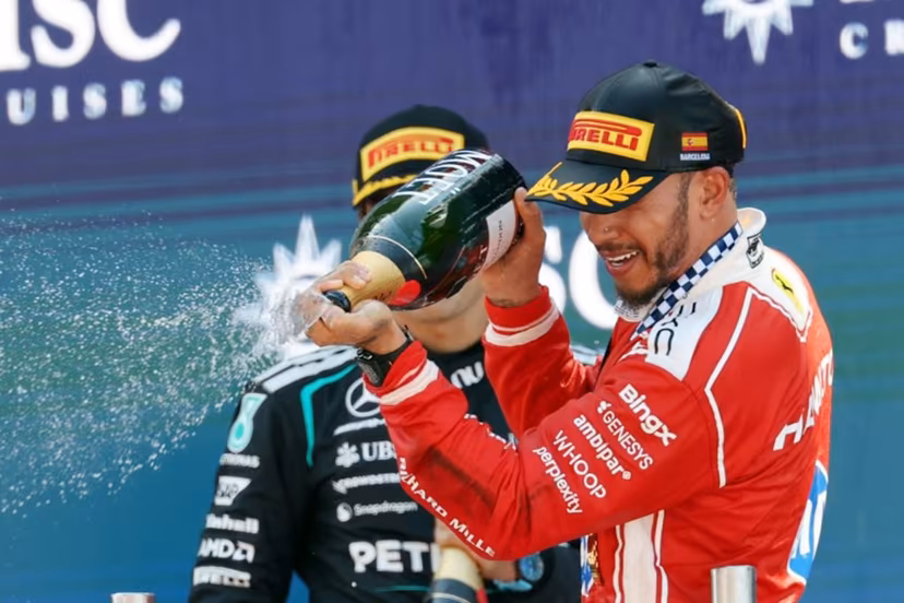 Winner Ferrari's British driver Lewis Hamilton (R) and second placed Mercedes' British driver George Russell celebrate in the podium after the Catalonia Formula One Grand Prix at the Circuit de Catalunya in Montmelo, on the outskirts of Barcelona, on June 14, 2026. Lluis GENE / AFP