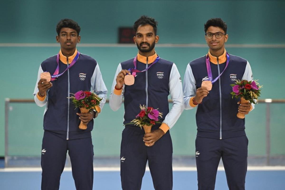 Bronze medallists India's Vikram Rajendra Ingale, Anandkumar Velkumar and Siddhant Rahul Kamble attend the awards ceremony of the men's 3000m relay speed skating event during the 2022 Asian Games in Hangzhou in China's eastern Zhejiang province on Octorber 2, 2023. WANG Zhao / AFP