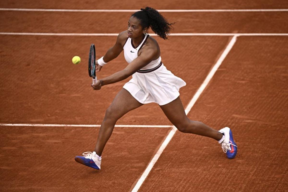 US Robin Montgomery plays a forehand return to France's Diane Parry during their women's singles match on day 2 of the French Open tennis tournament at the Roland-Garros Complex in Paris on May 26, 2025. JULIEN DE ROSA / AFP
