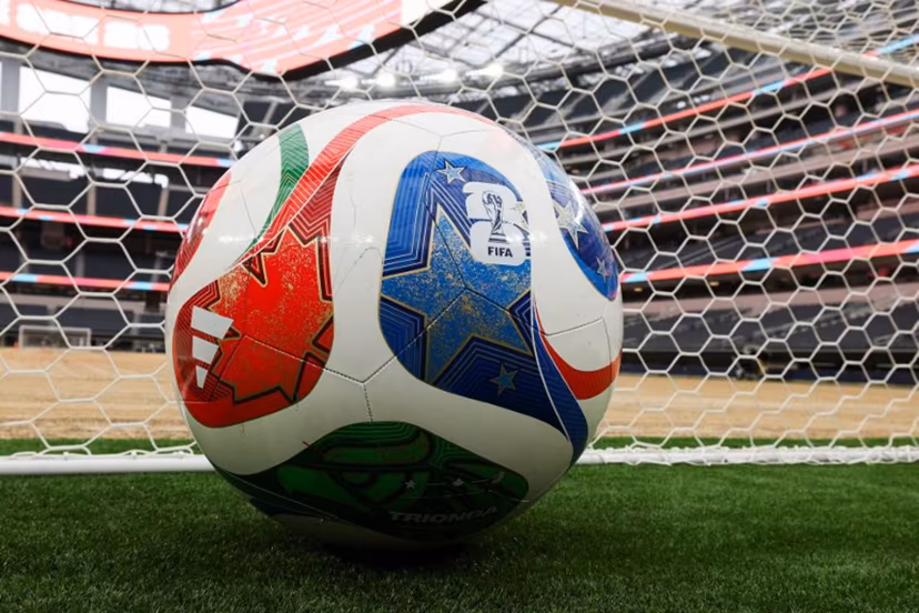 A giant ball is displayed behind a goal as an expanded pitch surface area, which required the removal of corner seating and a raised custom field platform, awaits the installation of grass during the 30 Days to FIFA World Cup 2026 media event at SoFI Stadium before the pitch installation and temporary renaming to Los Angeles Stadium in Inglewood, California on May 12, 2026. The US Men's National Team will play their first 2026 FIFA World Cup match on June 12 against Paraguay. Patrick T. Fallon / AFP