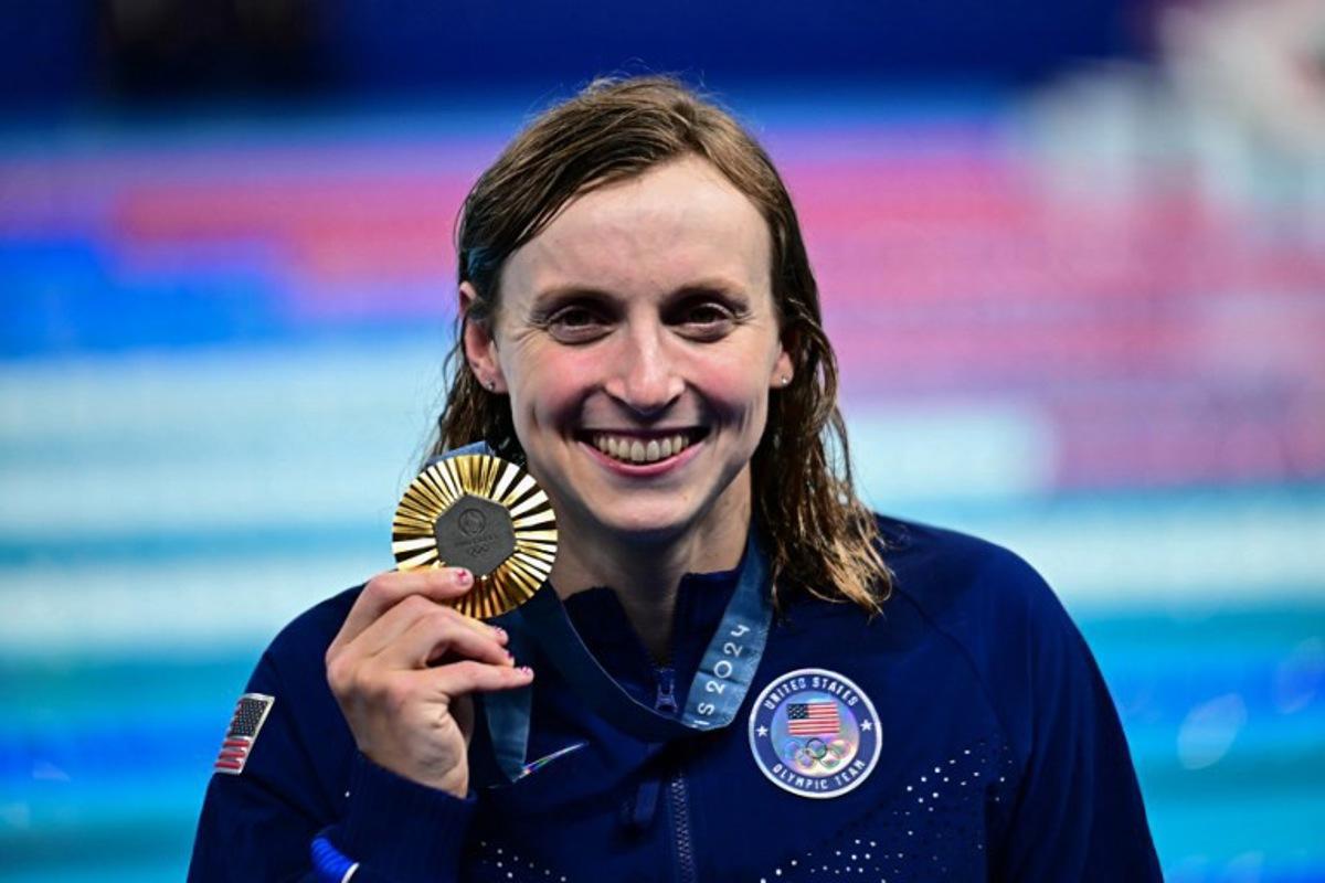 Gold medallist US' Katie Ledecky celebrates during the podium ceremony of the women's 800m freestyle swimming event during the Paris 2024 Olympic Games at the Paris La Defense Arena in Nanterre, west of Paris, on August 3, 2024. Manan VATSYAYANA / AFP