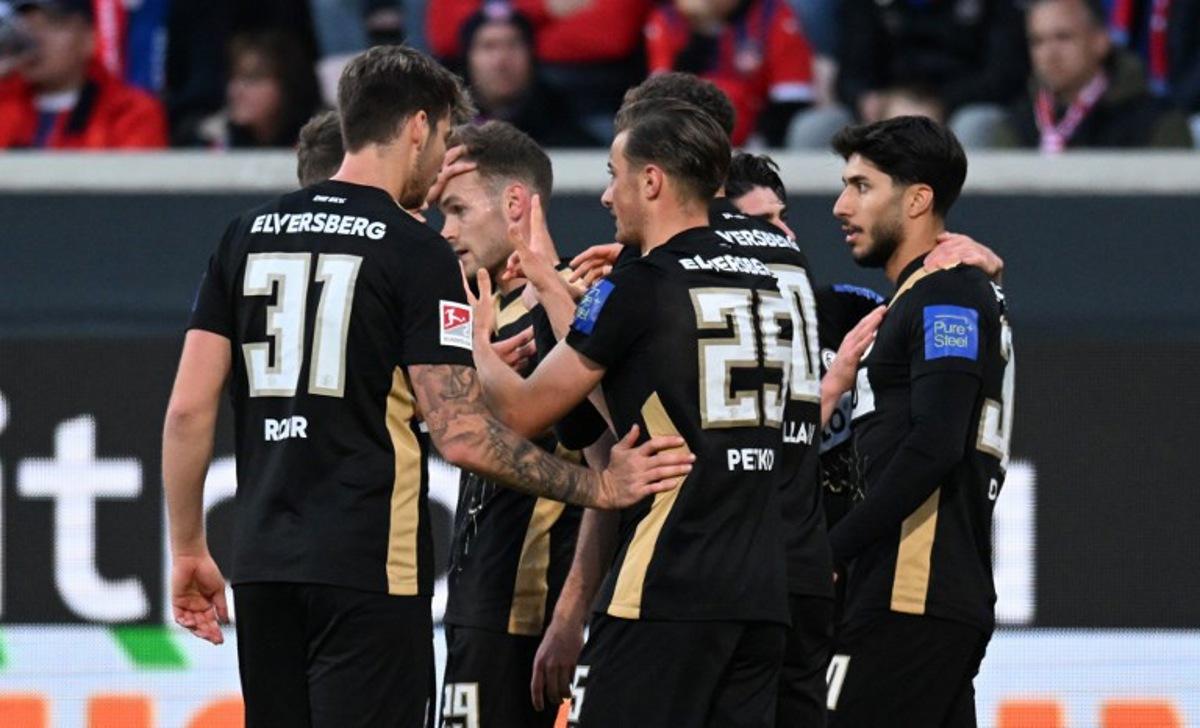 Elversberg's German midfielder #25 Lukas Petkov (R) celebrates with teammates scoring the opening goal during the German Bundesliga relegation first-leg football match between FC Heidenheim and SV Elversberg in Heidenheim on May 22, 2025. THOMAS KIENZLE / AFP