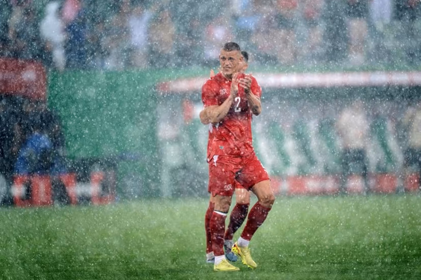 Switzerland's defender #2 Miro Muheim waves goodbye in the rain at the end of a friendly football match between Switzerland and Jordan ahead of the 2026 FIFA World Cup tournament at the Kybunpark in St. Gallen on May 31, 2026. Ennio LEANZA / AFP