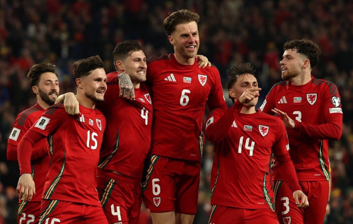 Wales' defender #04 Ben Davies (3L) celebrates scoring the team's second goal during the 2026 World Cup Group J qualifier football match between Wales and Kazakhstan, at Cardiff City Stadium, in Cardiff, on March 22, 2025. Adrian Dennis / AFP