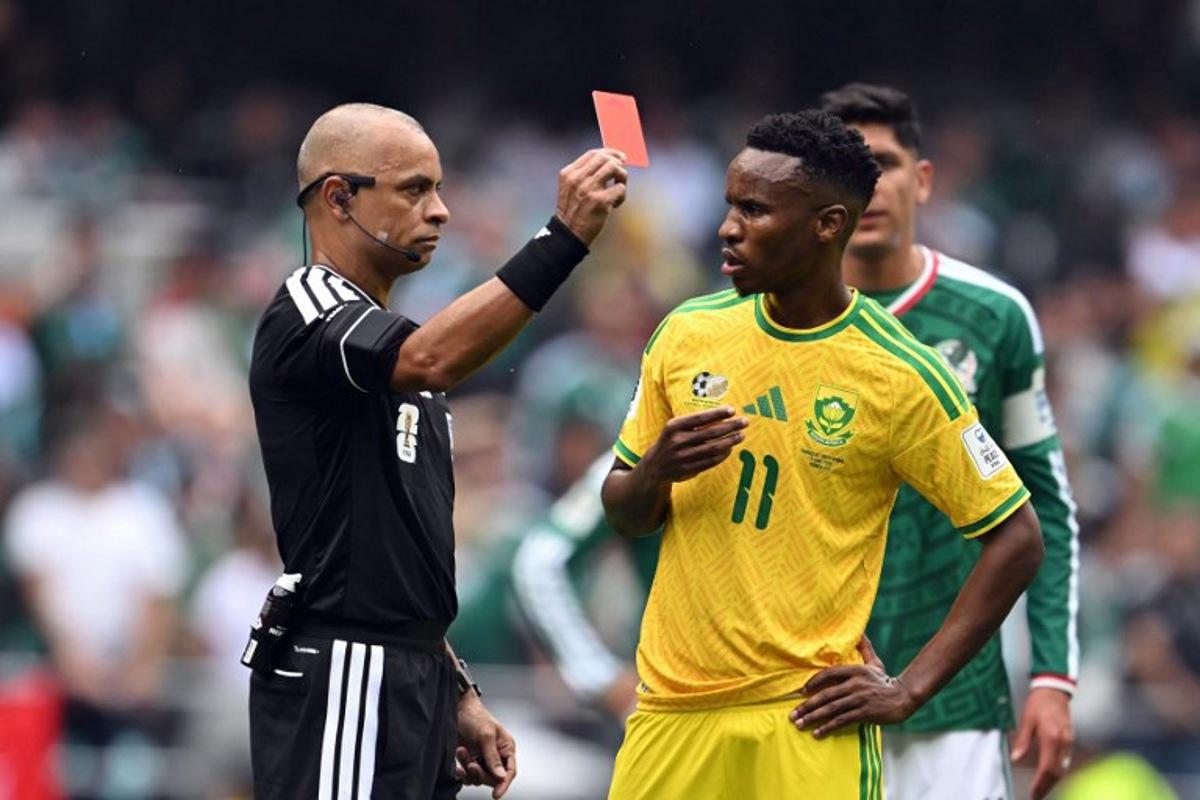 Brazilian referee Wilton Sampaio shows a red card to South Africa's midfielder #11 Themba Zwane during the 2026 World Cup Group A football match between Mexico and South Africa at the Mexico City Stadium in Mexico City on June 11, 2026. Yuri CORTEZ / AFP
