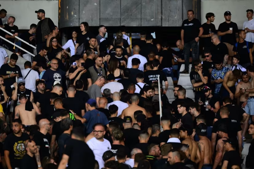 Juventus' supporters leave the stadium after a suspension of the Italian Serie A football match betweem Torino and Juventus FC at the Olympic Stadium Grande Torino in Turin on May 24, 2026. MARCO BERTORELLO / AFP