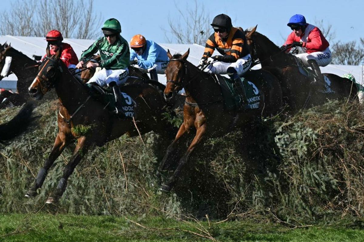 Jockey Patrick Mullins (2R) jumps The Chair on Nick Rockett on the first circuit on the way to winning the Grand National Handicap Chase on the final day of the Grand National Festival horse race meeting at Aintree Racecourse in Liverpool, north-west England, on April 5, 2025. Paul ELLIS / AFP