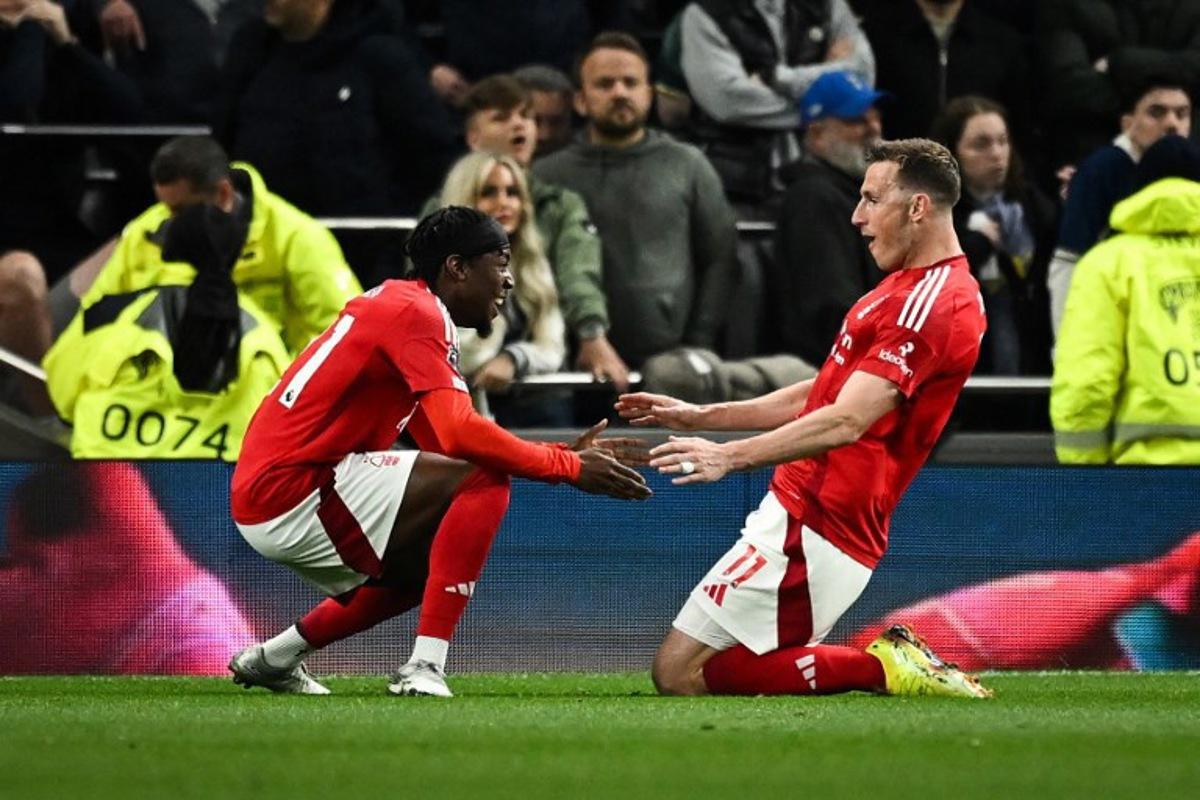 Nottingham Forest's New Zealand striker #11 Chris Wood (R) celebrates after scoring his team second goal during the English Premier League football match between Tottenham Hotspur and Nottingham Forest at the Tottenham Hotspur Stadium in London, on April 21, 2025. Ben STANSALL / AFP