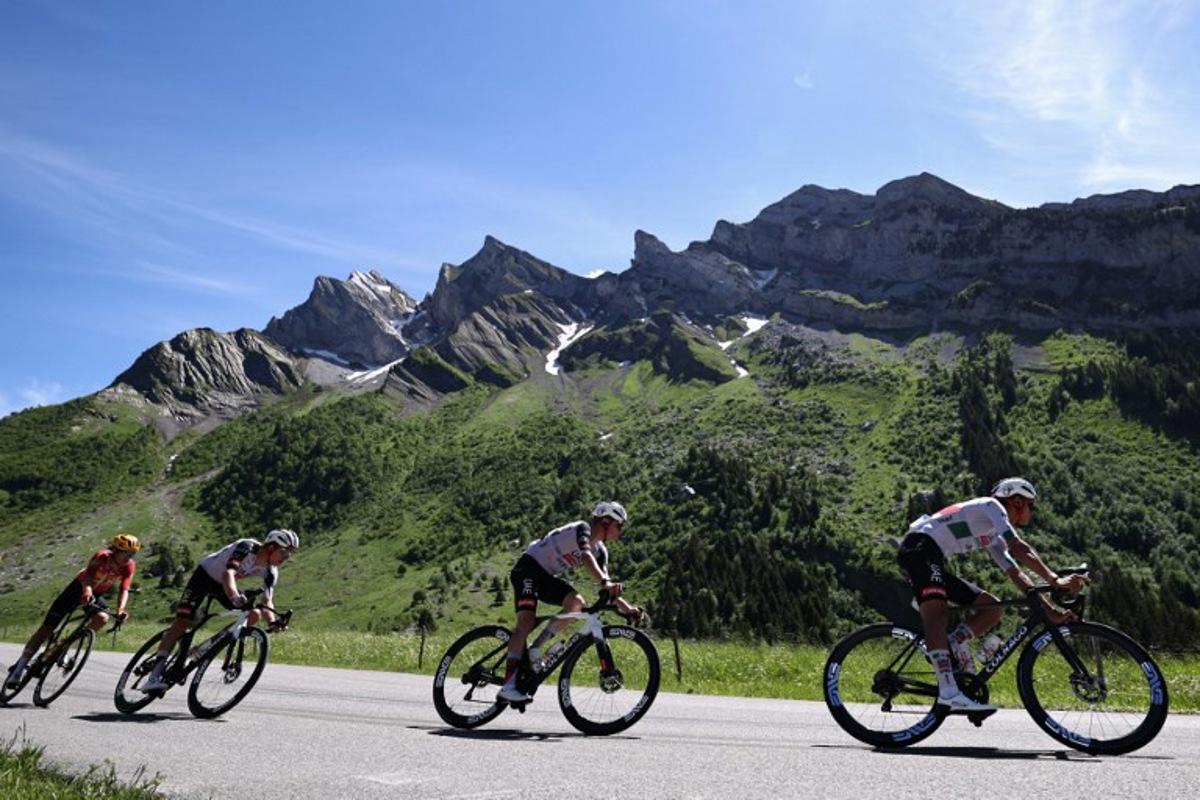 UAE Team Emirates XRG's Mexican rider Isaac Del Toro Romero (R) cycles in the descent of Col des Aravis during the 8th and final stage of the Tour Auvergne-Rhone-Alpes cycling race (formerly known as the Criterium du Dauphine), 120,1km between Beaufort and Plateau de Solaison, in the French Alps on June 14, 2026. Anne-Christine POUJOULAT / AFP