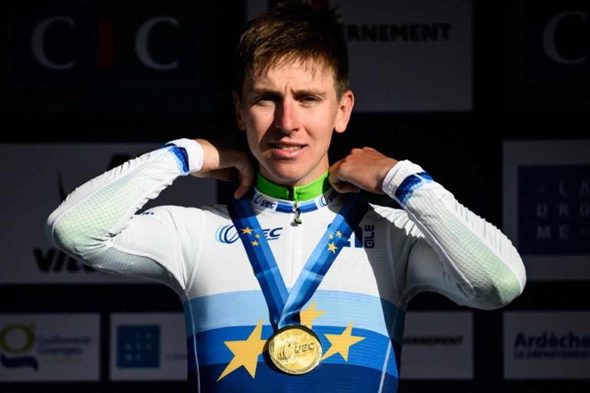 Slovenian rider Tadej Pogacar celebrates in the podium after winning the men's Elite Road Race at the European Cycling Championship 2025 near Valence, southeastern France on October 5, 2025. JEFF PACHOUD / AFP