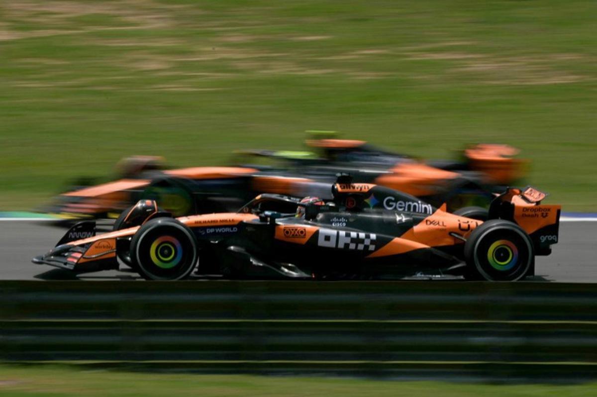 McLaren's British driver Lando Norris overtakes his teammate Australian driver Oscar Piastri during the practice session of the Sao Paulo Formula One Grand Prix at the Jose Carlos Pace racetrack, aka Interlagos, in Sao Paulo, Brazil on November 7, 2025. Nelson ALMEIDA / AFP