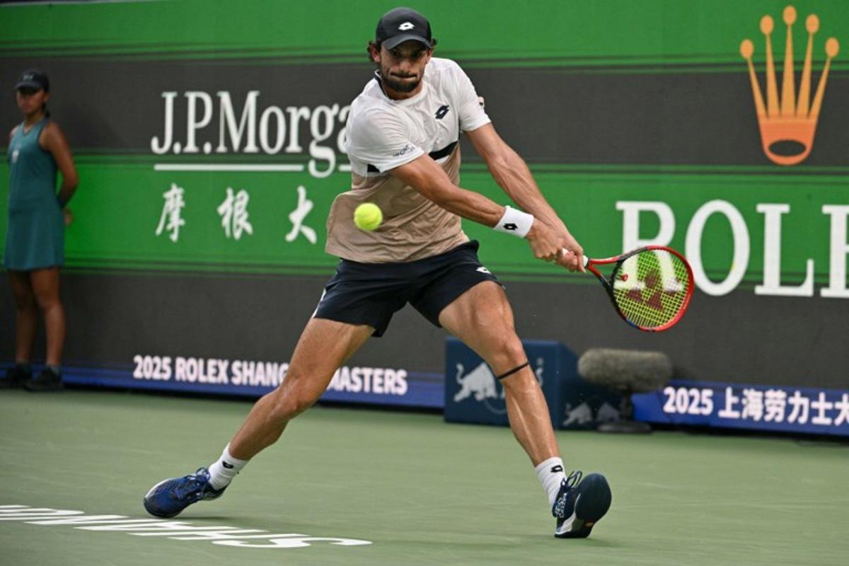 Monaco's Valentin Vacherot hits a return to Serbia's Novak Djokovic during their men's singles semi-final match at the Shanghai Masters tennis tournament in Shanghai on October 11, 2025. HECTOR RETAMAL / AFP