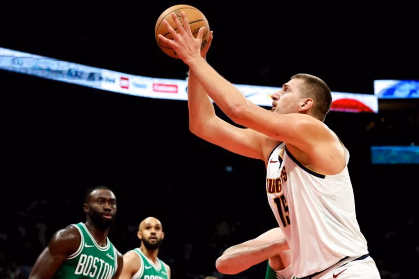 Denver Nuggets' center #15 Nikola Jokic jumps to shoot during the NBA Preseason game between the Boston Celtics and the Denver Nuggets at the Etihad Arena in Abu Dhabi on October 6, 2024. Fadel Senna / AFP