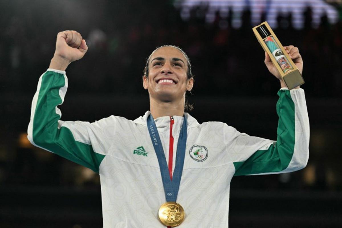 Gold medallist Algeria's Imane Khelif poses on the podium during the medal ceremony for the women's 66kg final boxing category during the Paris 2024 Olympic Games at the Roland-Garros Stadium, in Paris on August 9, 2024. MOHD RASFAN / AFP