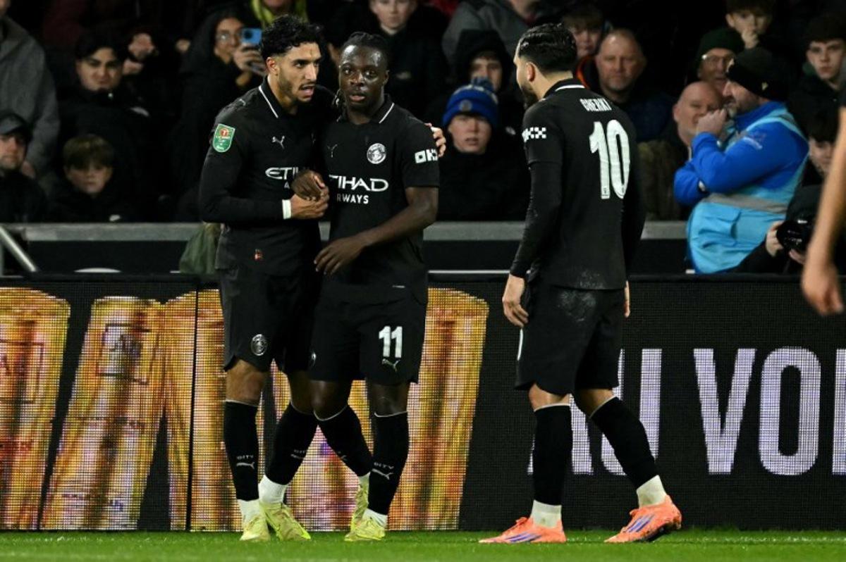 Manchester City's Egyptian striker #07 Omar Marmoush (L) celebrates scoring the team's second goal during the English League Cup fourth round football match between Swansea City and Manchester City at the Swansea.com stadium, in south Wales on October 29, 2025. JUSTIN TALLIS / AFP