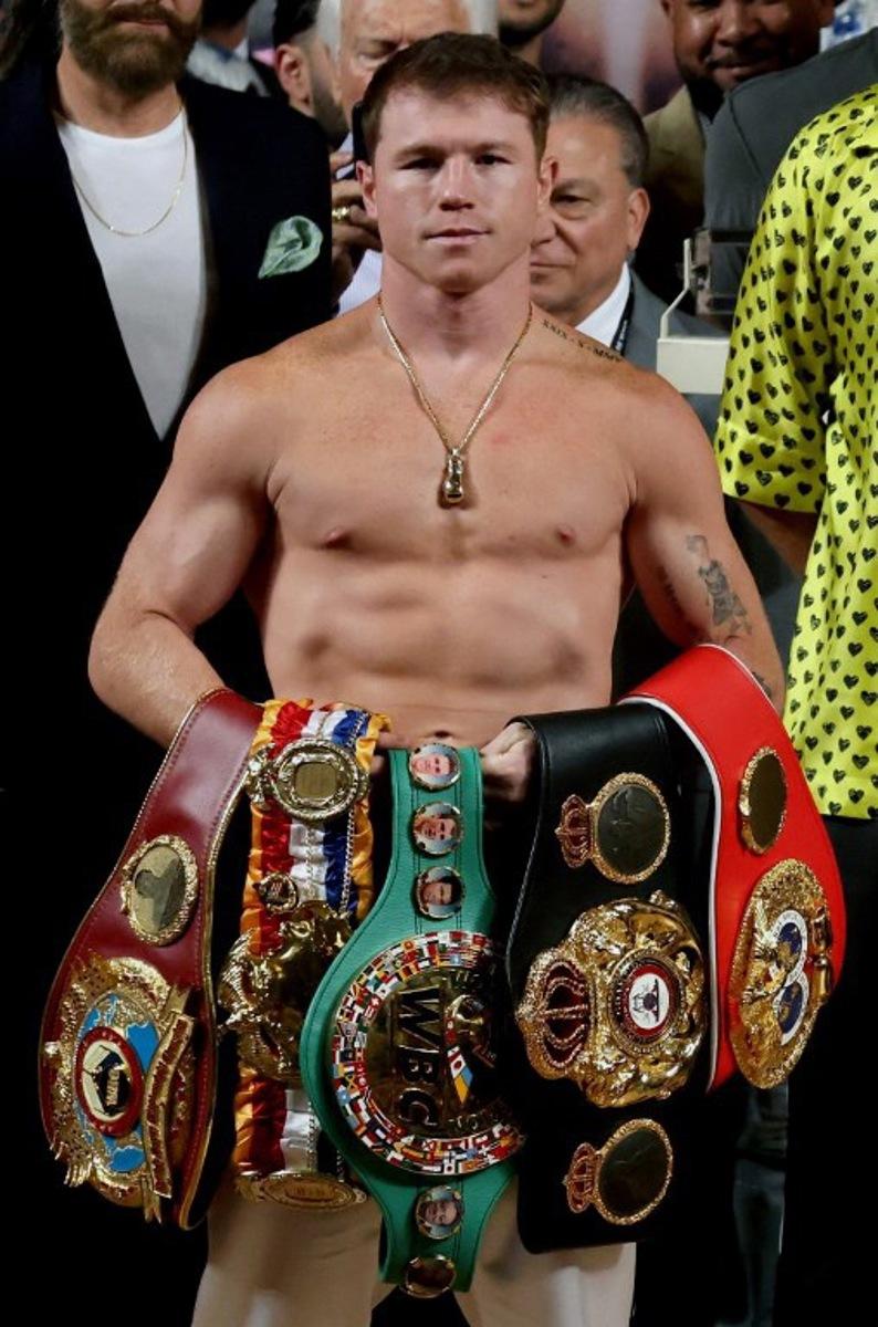 Mexican boxer Saul "Canelo" Alvarez poses with his belts before the weighing ceremony prior to his fight against British boxer John Ryder for the WBA, WBC, IBF and WBO super middleweight titles in Guadalajara, Mexico, on May 5, 2023. ULISES RUIZ / AFP
