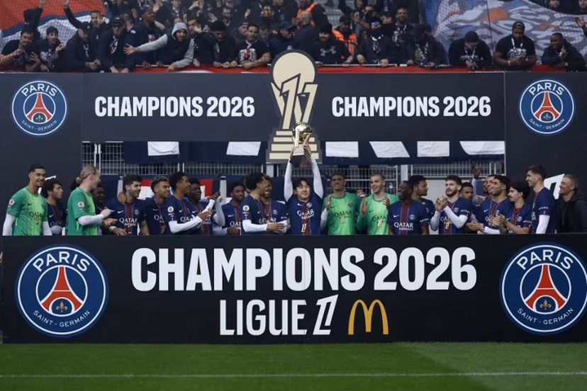 Paris Saint-Germain's South Korean midfielder #19 Lee Kang-in (C) lifts the French Ligue 1 trophy as he celebrates alongside teammates after winning the championship ahead of the French L1 football match between Paris FC and Paris Saint-Germain (PSG) at the Stade Jean-Bouin in Paris on May 17, 2026. Kenzo TRIBOUILLARD / AFP